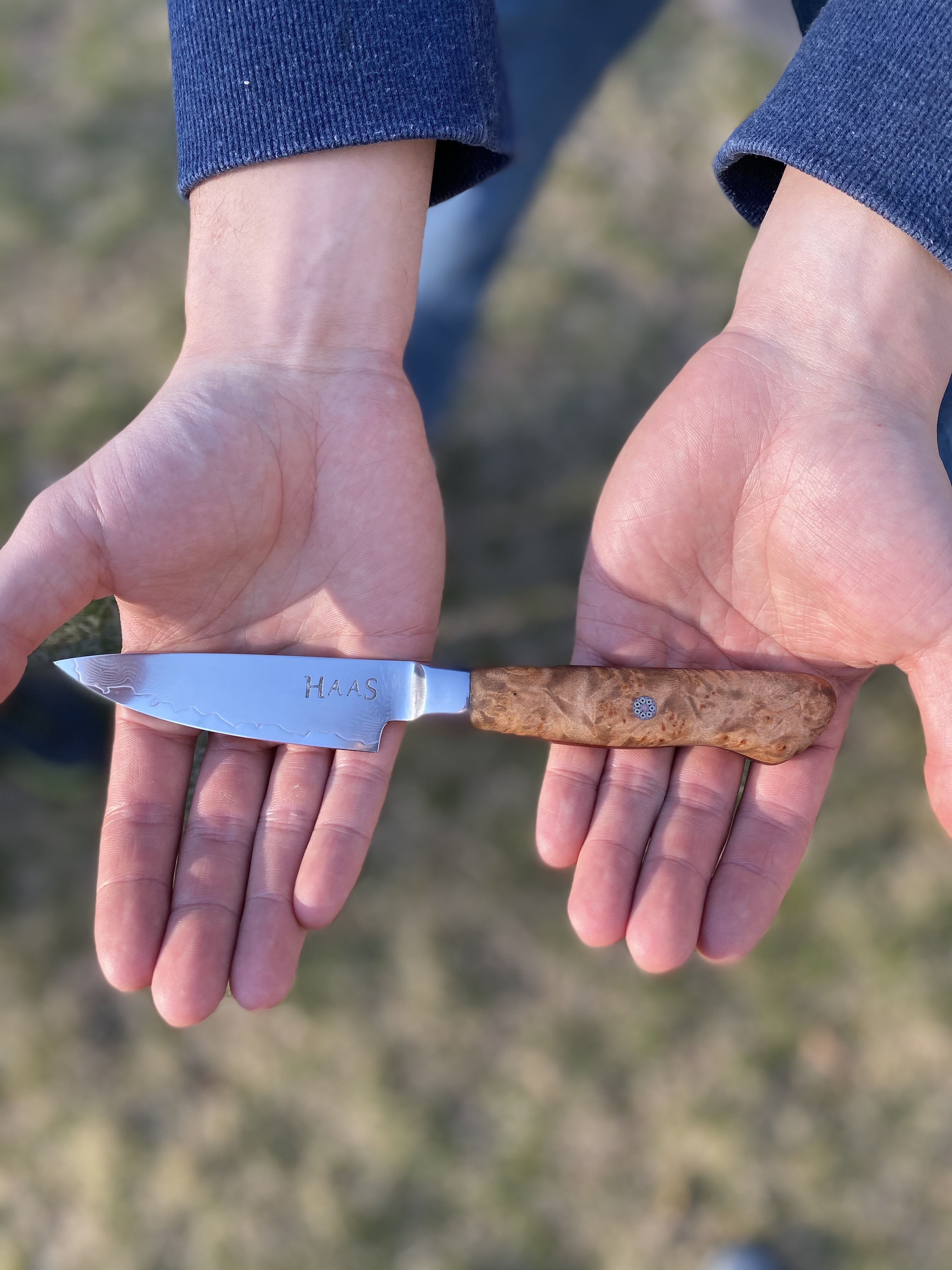 Petty knife held in two hands outside
